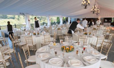 Tables set at an outdoor wedding after party