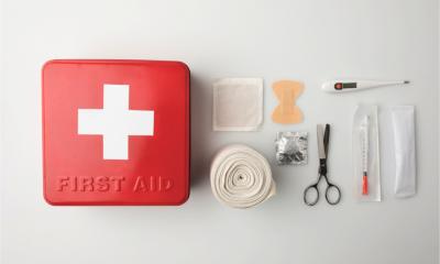 Top view of first-aid kit representing the aid and support available to struggling businesses during the COVID-19 outbreak rmometer and elastic bandage