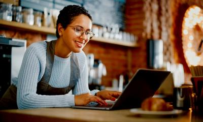 An attractive woman completes her start up tasks online