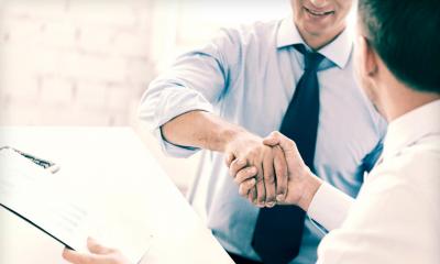 A man completes the contract to buy a business