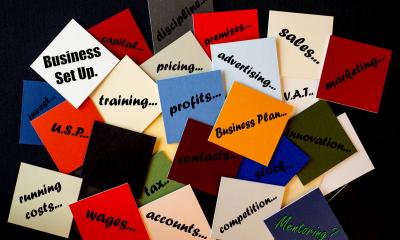 Sticky notes with startup costs elements written on them