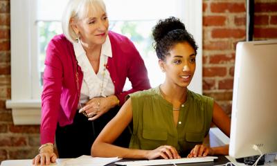 A mature business woman mentors a younger woman