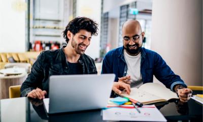 Two business owners registering a business name online