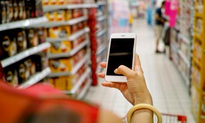 A shopper walking through an isle in a supermarket