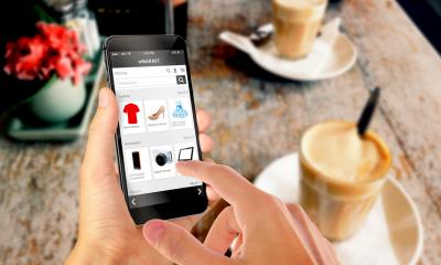 A woman places an online order via her mobile phone
