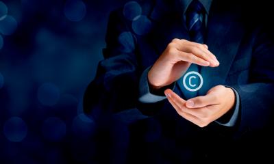 Protecting your intellectual property - checklist person cupping hands, with the letter c floating in the middle