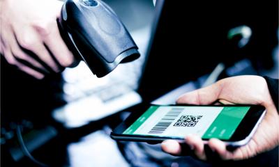 A customer uses a QR code to get a discount in a store