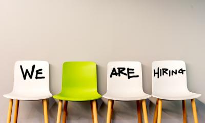 Recruiting - checklist One green chair and three white chairs in a row with writing on