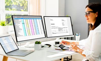 A woman updates her business accounts using online accounting software
