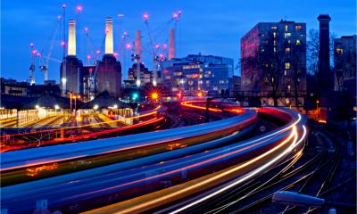 Trains running smoothly past Battesea Power station at dusk
