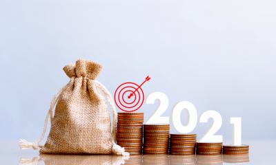 2021 and Coins stack. SAlary or dividend concept.