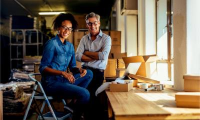 Smiling business partners move into their new business
