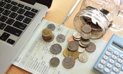 Coins on table with calculator