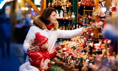 Woman and two children shopping for Christmas decorations