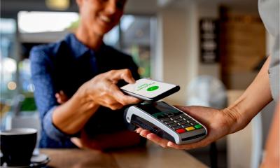 A customer pays for goods using contactless technology