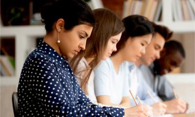 Multi-ethnic sales team complete a skills assessment