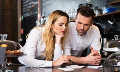 Small business owners checking their sales and receipts