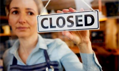 A worried woman closes her business due to the pandemic