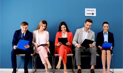 A group of candidates sit and wait to be interviewed