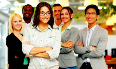 Six employees stood with their arms crossed in a group wearing corporate clothing