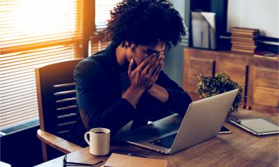 A woman of colour is feeling the stress in her small business