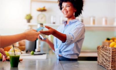 A female employee takes a card payment from a customer