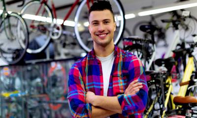 A male business owner poses in his bicycle shop
