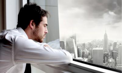 A man is looking out of a window - looking at the future