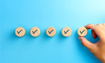 Checklist concept, Check mark on wooden blocks against a blue background