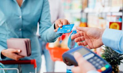 Women paying for for her shopping using her debit card