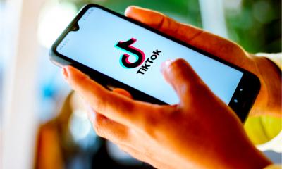 Someone opens the TikTok app on their smartphone