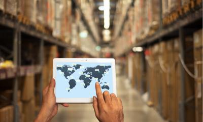 A person looking at a world map in warehouse setting