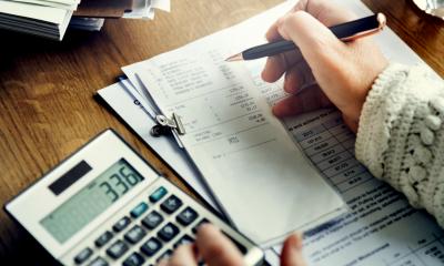 Business person performing VAT calculations