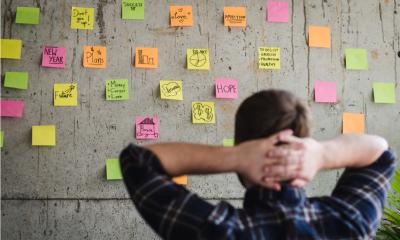 An entrepreneur looking at a wall filled with sticky notes