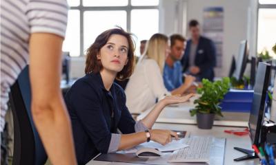 Employees discussing an issue in a business office