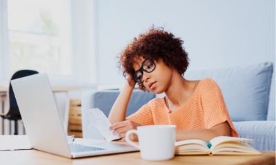 Young women looking stressed while looking at her computer