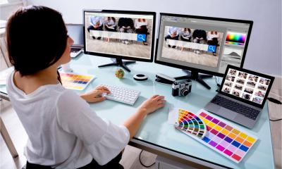 An attractive female works at her desk designing and building a website