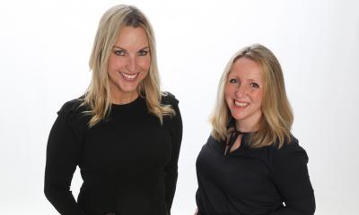 The two founders of the YUUbag wearing black tops smiling at the camera